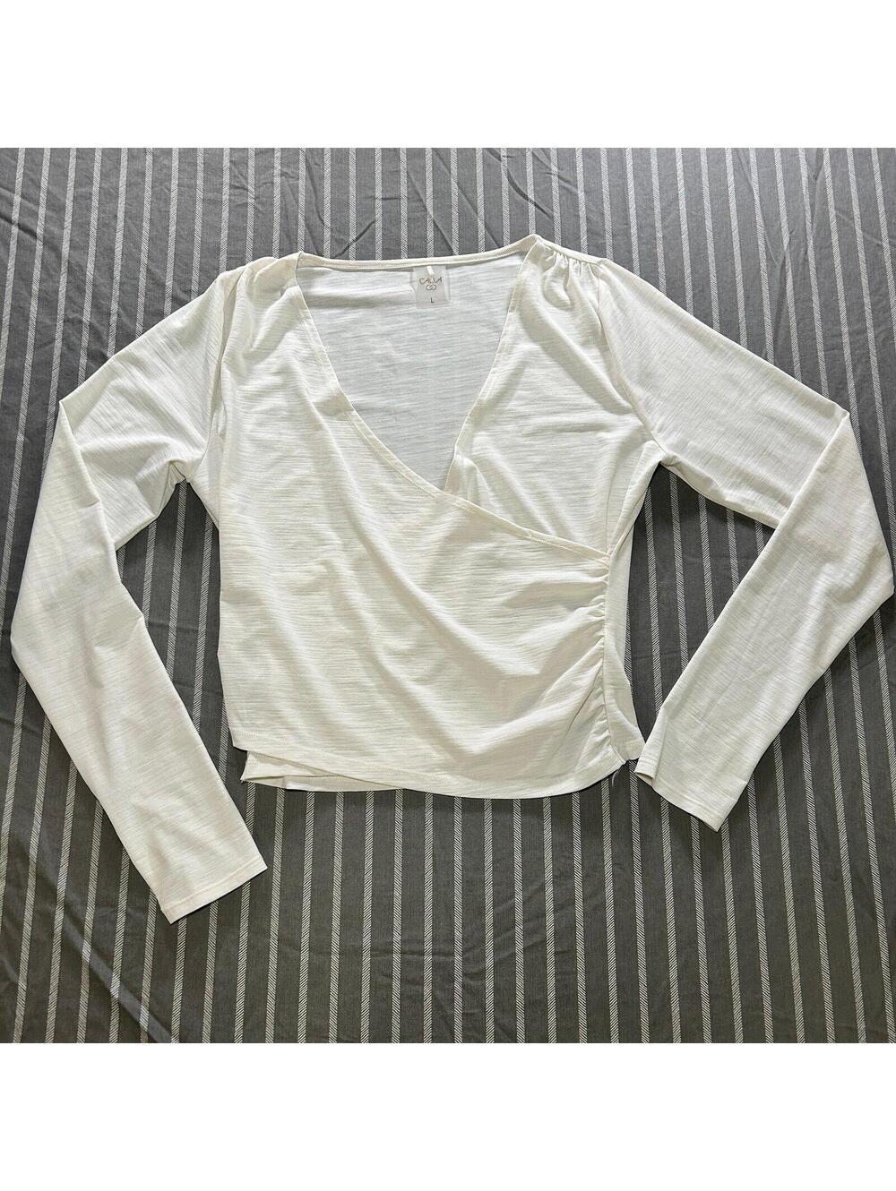CALIA Carrie Underwood Women's Long Sleeve Wrap Top in white size Large
